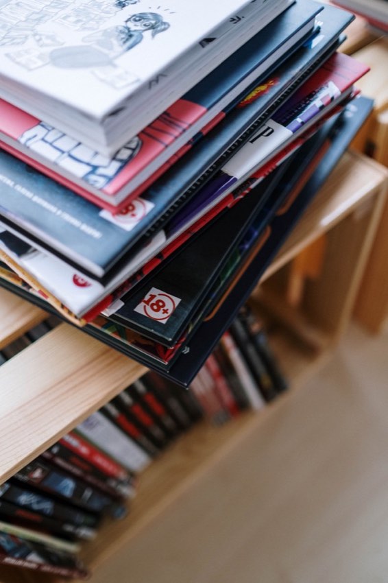 Illustrative photograph of a stack of comic art books